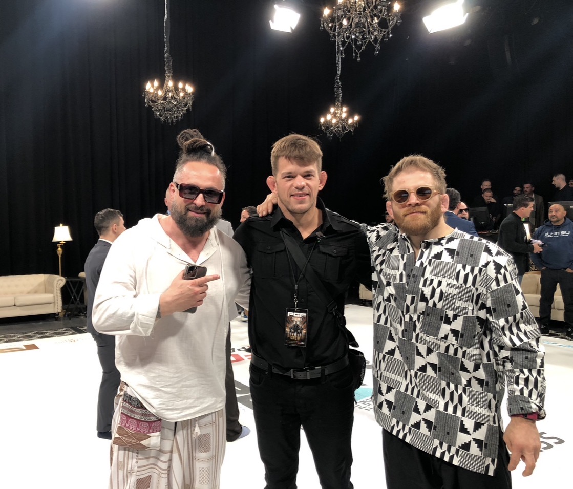 Paul with two fellow attendees at a grappling event